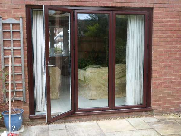 Mr T, Wigan : Installation of Centor C1 Bi-fold doors with 44m triple glazing. The doors are sprayed with a dual finish with brown on the outside and white inside.